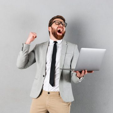 Portrait of a cheerful businessman dressed in suit